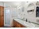 Well-lit bathroom with dual sinks and a glass-enclosed shower at 5036 18Th N St, St Petersburg, FL 33714