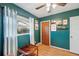 This bedroom features green paint, wood floors and a ceiling fan at 5036 18Th N St, St Petersburg, FL 33714