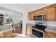 Kitchen features stainless steel oven and microwave with wood cabinets and a view to the dining area at 5036 18Th N St, St Petersburg, FL 33714