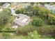 Bird's-eye view of a property with a large backyard, mature trees, and convenient outdoor structure at 5443 Ott Ct, Spring Hill, FL 34608