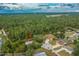 Aerial view of the neighborhood, surrounded by lush greenery and mature trees, highlighting the property's location at 5443 Ott Ct, Spring Hill, FL 34608
