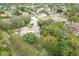 Aerial view of a home and community featuring mature trees, well-maintained landscaping, and surrounding neighborhood at 5443 Ott Ct, Spring Hill, FL 34608