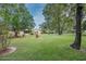 Spacious backyard view features mature trees, landscaping, and an inviting outdoor area for relaxation at 5443 Ott Ct, Spring Hill, FL 34608