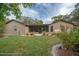 Manicured backyard featuring a patio, garden with decorative items and lush lawn at 5443 Ott Ct, Spring Hill, FL 34608