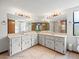 Primary bathroom with double sinks, large mirror, and ample counter and storage space at 5443 Ott Ct, Spring Hill, FL 34608
