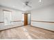 Spacious bedroom with wood-look flooring, white walls, and a ceiling fan for added comfort at 5443 Ott Ct, Spring Hill, FL 34608