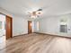 Bright bedroom with wood-look flooring, ceiling fan, natural light, and a closet at 5443 Ott Ct, Spring Hill, FL 34608