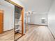 Large bedroom with wood-look flooring, a ceiling fan, natural light, and a mirrored closet at 5443 Ott Ct, Spring Hill, FL 34608