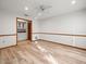 Bright bedroom with wood-look floors, neutral walls, and a glimpse into a connected kitchenette at 5443 Ott Ct, Spring Hill, FL 34608