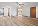 Spacious bedroom featuring wood-look flooring, a ceiling fan, and two entry doorways at 5443 Ott Ct, Spring Hill, FL 34608
