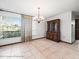 Dining space featuring a large window, decorative curtains, and a classic wooden cabinet at 5443 Ott Ct, Spring Hill, FL 34608