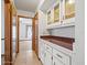 Hallway with tile floors, lots of built-in cabinets, and glimpses of connected rooms at 5443 Ott Ct, Spring Hill, FL 34608