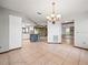 Open concept kitchen with tile flooring and a center island with seating, adjacent to additional living spaces at 5443 Ott Ct, Spring Hill, FL 34608