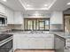 Kitchen area with a large window overlooking the back yard, stainless appliances, and granite counters at 5443 Ott Ct, Spring Hill, FL 34608