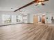Spacious living room featuring hardwood floors, vaulted ceilings, and large windows with scenic outdoor views at 5443 Ott Ct, Spring Hill, FL 34608