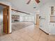 Inviting living room with a stone fireplace and open access to the dining area, offering a cozy and connected space at 5443 Ott Ct, Spring Hill, FL 34608