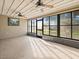 Enclosed sun room with a ceiling fan, large windows bringing in natural light, and view of the outdoors at 5443 Ott Ct, Spring Hill, FL 34608