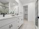 Elegant bathroom with double vanity, modern fixtures, and a glass-enclosed shower at 6213 64Th N Way, Pinellas Park, FL 33781