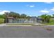 The community pool features a secure fence, palm trees, and lounge chairs for relaxation at 6213 64Th N Way, Pinellas Park, FL 33781
