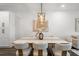 Bright dining area with modern decor, neutral color scheme, and stylish overhead lighting at 6213 64Th N Way, Pinellas Park, FL 33781