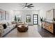 Bright living room features a neutral color palette, a geometrically shaped coffee table, and stylish furnishings at 6213 64Th N Way, Pinellas Park, FL 33781
