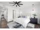 Bright main bedroom with a pendant light, geometric rug, and an ensuite bathroom at 6213 64Th N Way, Pinellas Park, FL 33781