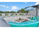 An inviting pool area featuring lounge seating, tables, and decorative umbrellas for a relaxing outdoor experience at 6213 64Th N Way, Pinellas Park, FL 33781