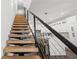 Modern staircase with wood treads and metal railing, leading to the upper level at 6213 64Th N Way, Pinellas Park, FL 33781