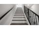Staircase with white risers, wooden treads, and a black iron railing at 6213 64Th N Way, Pinellas Park, FL 33781