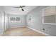 Bedroom featuring wood floors, a ceiling fan, and natural light from two windows at 6291 63Rd N St, Pinellas Park, FL 33781