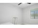 Bright bedroom featuring a ceiling fan, light walls and a white table and chair at 6291 63Rd N St, Pinellas Park, FL 33781
