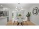 Dining space features modern chandelier, glass table and view into the kitchen at 6291 63Rd N St, Pinellas Park, FL 33781