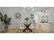 Open dining area features modern lighting and a glass table with seating for four at 6291 63Rd N St, Pinellas Park, FL 33781