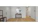 Close-up of entryway with hardwood floors, console table, and front door at 6291 63Rd N St, Pinellas Park, FL 33781