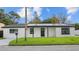 Charming single-story home with a well-maintained lawn and dark trim accents at 6291 63Rd N St, Pinellas Park, FL 33781