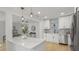Bright kitchen features white cabinetry, stainless steel appliances, and a stylish quartz countertop island at 6291 63Rd N St, Pinellas Park, FL 33781