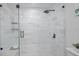 Walk-in shower featuring gray marble tile, a shower bench, and a modern shower head at 6291 63Rd N St, Pinellas Park, FL 33781