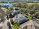 Drone shot of homes with a lake view, showcasing neighborhood and landscaping at 6640 Park Strand Dr, Apollo Beach, FL 33572