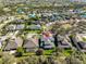 An aerial view showcases the home's in-ground pool and a well-maintained lawn and landscaping at 6640 Park Strand Dr, Apollo Beach, FL 33572