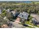 Aerial view of home with large brick driveway and a large pond in the distance at 6640 Park Strand Dr, Apollo Beach, FL 33572