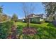 Picturesque backyard with lush lawn, mature trees, and a charming garden area at 6640 Park Strand Dr, Apollo Beach, FL 33572
