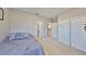 Comfortable bedroom with neutral walls, double closets, and a doorway leading to the hallway at 6640 Park Strand Dr, Apollo Beach, FL 33572