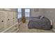 Bedroom with a comfy bed, natural light from windows, and a decorative teddy bear at 6640 Park Strand Dr, Apollo Beach, FL 33572