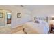 Bright bedroom with a plush bed, closet, and an open doorway leading to the bathroom at 6640 Park Strand Dr, Apollo Beach, FL 33572