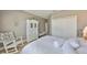 Cozy bedroom with a rocking chair, decorative mirror, and detailed white armoire at 6640 Park Strand Dr, Apollo Beach, FL 33572