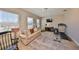 Large bonus room featuring a treadmill, sofa, and natural light from multiple windows at 6640 Park Strand Dr, Apollo Beach, FL 33572