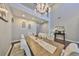 Dining room with chandelier, large table, and seating for eight at 6640 Park Strand Dr, Apollo Beach, FL 33572