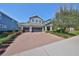 Charming home featuring a manicured front yard, brick driveway and a 2-car garage at 6640 Park Strand Dr, Apollo Beach, FL 33572