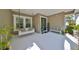 Inviting front porch with sitting bench and hanging swing at 6640 Park Strand Dr, Apollo Beach, FL 33572