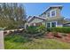 Landscaped front yard with grass, plants, mulch and a large tree at 6640 Park Strand Dr, Apollo Beach, FL 33572